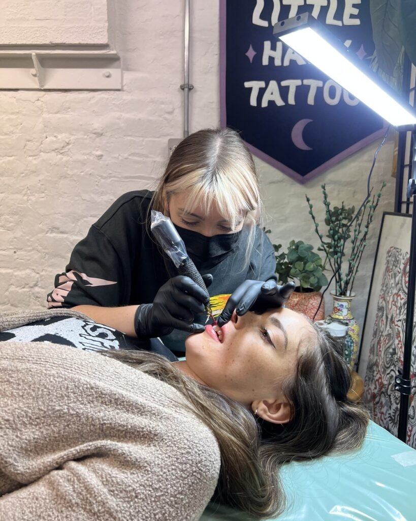 Dani tattooing semi-permanent lip blush on a client at Little Hawk Studio