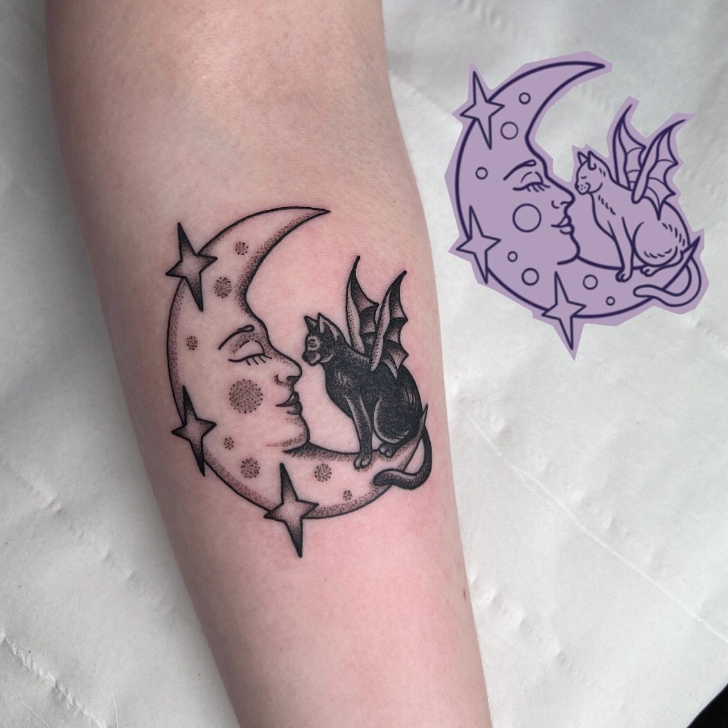 One of Gem Hawk's flash designs next to the finished tattoo, a crescent moon with a winged cat